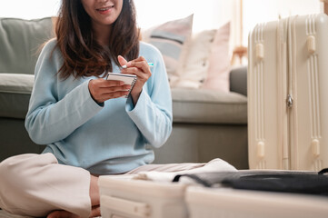 luggage, baggage, bag, tourist, traveler, packing, person, room, message, passenger. A woman sits...