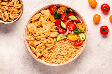 Bowl of quinoa with vegan soy meat and vegetables.