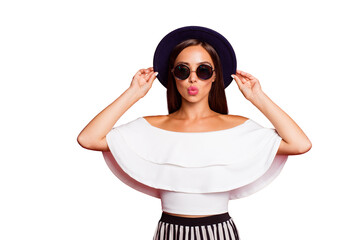 Portrait of nice charming tender attractive adorable magnificent straight-haired lady wearing white off-the-shoulders ruffles top blouse touching hat air kiss isolated over pastel red background