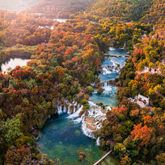 Krka, Croatia - Aerial panoramic view of the famous Krka Waterfalls in Krka National Park on a sunny autumn morning with colorful autumn foliage sunlight