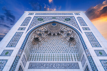 white marble tiles wall decorated traditional Uzbek Islamic pattern ornament on the Minor Mosque in...