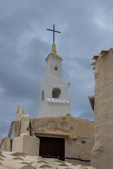 Charming corner of the picturesque and white town of Binibeca Vell, with the Church in the background. Menorca, Spain