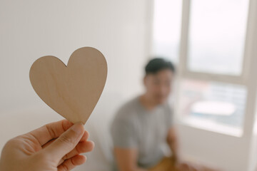 Photo of woman hand holding wooden empty space of heart design, showing love gesture and giving to man, lovely couple marriage, valentines concept.