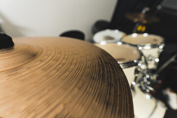 Close-up of drum bronze cymbal plate in music studio. High quality photo