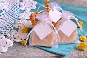 Wedding favor diy handmade soap in organza bag on blue background, baby boy shower custom souvenir