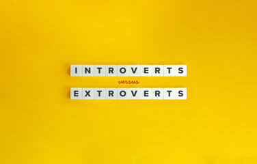 Introverts versus Extroverts Banner and Concept Image. Text on Block Letter Tiles on Yellow Background. Minimal Aesthetic
