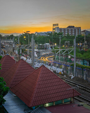view of the city at sunset in yogyakarta city with train or railroads