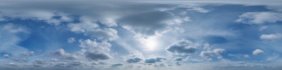 blue sky with haze in 360 hdri panorama in equirectangular format with zenith and clouds and sun for use in 3d graphics or game development as skydome or edit drone shot or sky replacement