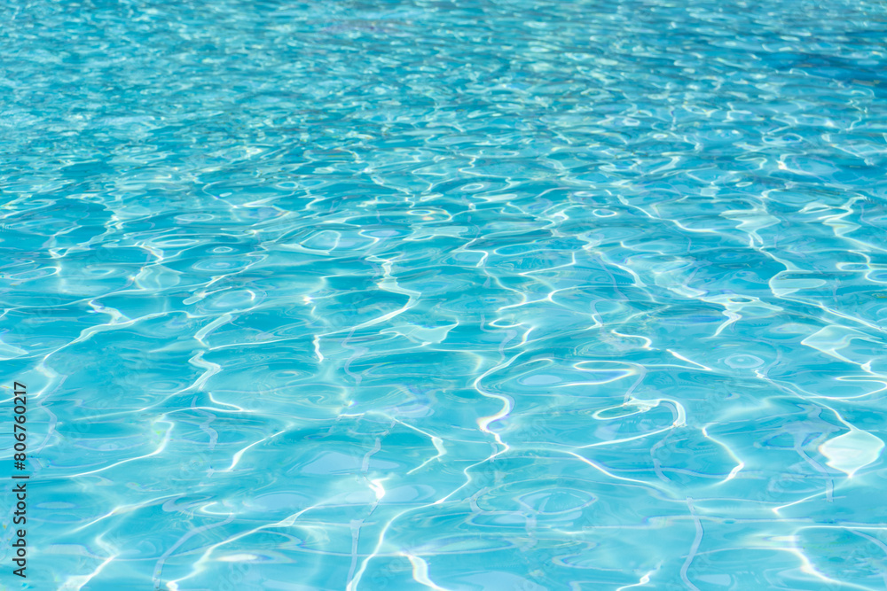 Wall mural blue swimming pool water surface and ripple wave background. summer abstract reflection caustics in 