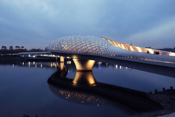 The Atyrau Bridge in the capital of Kazakhstan, Astana, connects the right and left banks of the Ishim (Yesil) River. The bridge is pedestrian, unusually and beautifully illuminated, modern, art, buil