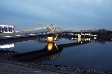 The Atyrau Bridge in the capital of Kazakhstan, Astana, connects the right and left banks of the Ishim (Yesil) River. The bridge is pedestrian, unusually and beautifully illuminated.