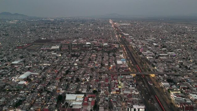 Panoramic aerial view of Ecatepec neighborhood, CDMX Suburbs, Sunset Illuminates City