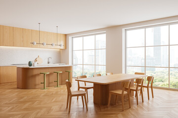 Stylish home kitchen interior with bar counter and dining table near window