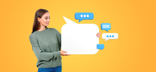 A woman holding a large, blank mockup speech bubble with smaller
