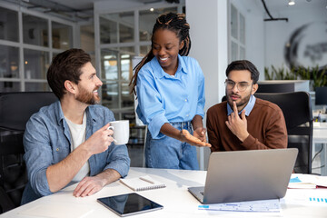 Group of diverse businesspeople using laptop while working together