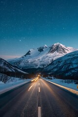 A long road leading to the distance, snow-covered mountains under a starry sky