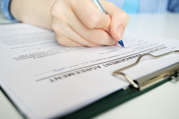 Property management agreement, hand fills out a document, rental deal, landlord, real estate sale,...