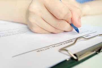 Employment verification letter, hand fills out a document, desk paperwork, corporate meeting.