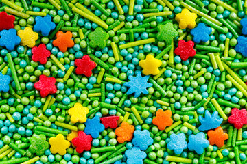 The texture of candy sprinkles.Varied sugar sprinkles, stars, flowers, dots.Holiday treat.Toppings...