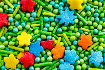 The texture of candy sprinkles.Varied sugar sprinkles, stars, flowers, dots.Holiday treat.Toppings...