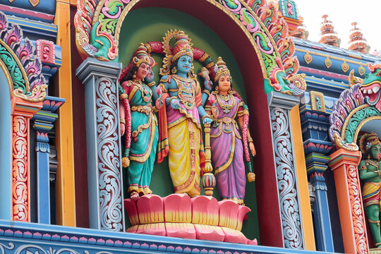 God Vishnu or Janardana Swami with his consorts Sri Devi and Bhu Devi. Stucco molding on the roof of a temple in Varkala, Kerala, India.