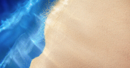 summer background with sea sand and sea waves, top view