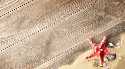 wooden background with sand, starfish and shells, top view