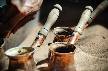 Preparing local coffee on hot sand