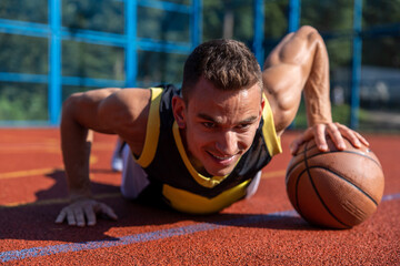 Handsome basketball player having workout on outdoor court