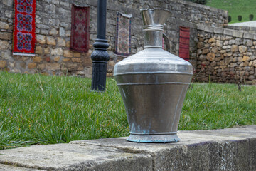Antique metal vessels for water and wine. A copper jug in an ancient fortress. Antique handmade...