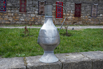 Antique metal vessels for water and wine. A copper jug in an ancient fortress. Antique handmade...