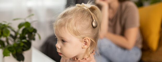 Banner Cochlear implant system copy space. Installation cochlear implant on child girl ear for...