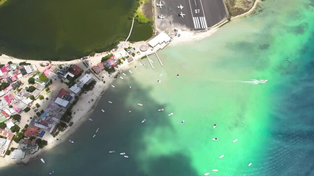 Los roques archipelago with boats and clear turquoise waters, tilt-up shot, aerial view