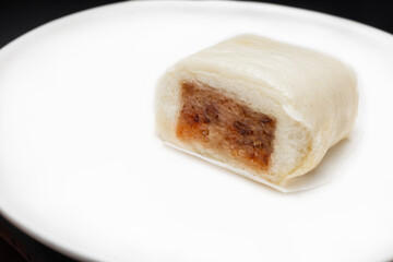 Baozi or Mantou, dim sum-Chinese steamed meat bun serving on white plate
