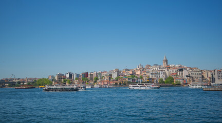 Obraz premium Touristic sightseeing ships in Golden Horn bay against blue sky and clouds. Istanbul, Turkey. During sunny summer day.