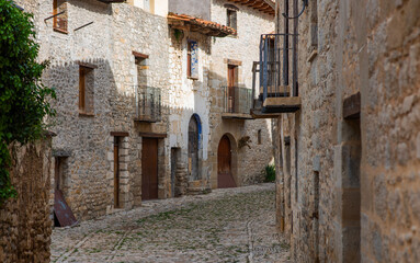Old charming streets. Typical village with stone facades. Architecture and sights of Spain.