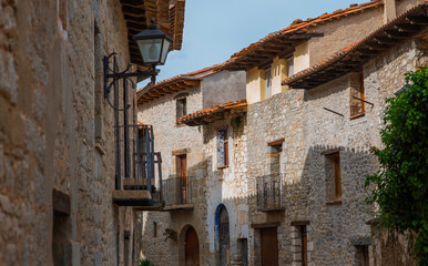 Old charming streets. Typical village with stone facades. Architecture and sights of Spain.