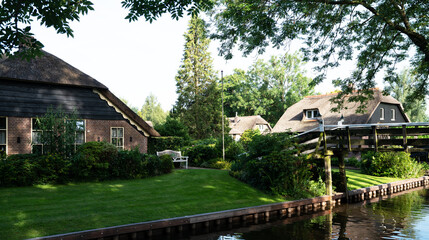 Fototapeta premium Typical houses of Giethoorn, Netherlands with gardens. Town is know as 