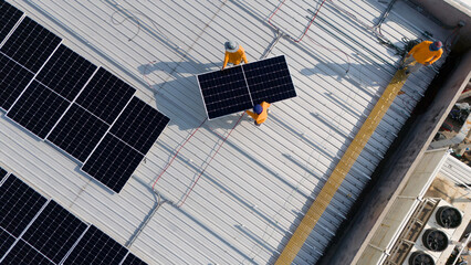Aerial top view of a technician drone installing solar panels on the roof..