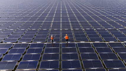 Professional workers clean and inspect solar panels on a floating buoy. Power plant with water.