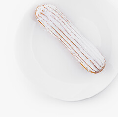 Fresh eclair on white plate