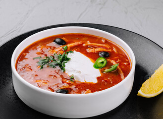 Spicy tomato soup with cream and herbs