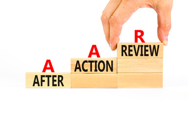 AAR After action review symbol. Concept words AAR After action review on beautiful wooden blocks. Businessman hand. Beautiful white background. Business AAR after action review concept. Copy space.