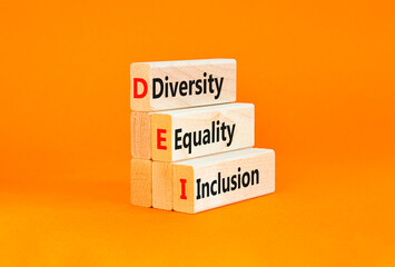 Naklejka premium DEI diversity equality inclusion symbol. Concept words DEI diversity equality inclusion on blocks. Beautiful orange background. Business DEI diversity equality inclusion concept. Copy space.