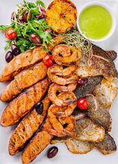 Grilled seafood and fish platter with fresh salad