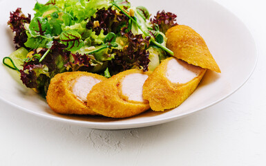 Chicken nuggets on a plate on white