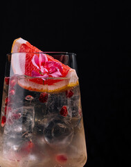 Elegant cocktail with citrus garnish on dark background