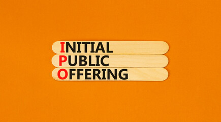 IPO initial public offering symbol. Concept words IPO initial public offering on beautiful wooden stick. Beautiful orange background. Business IPO initial public offering concept. Copy space.
