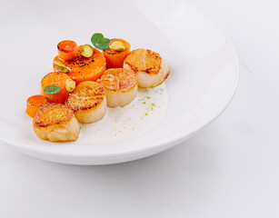 Elegant scallops appetizer on white plate