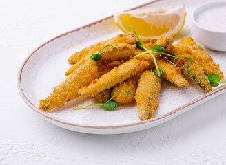 Crispy fried fish fingers with lemon and tartar sauce